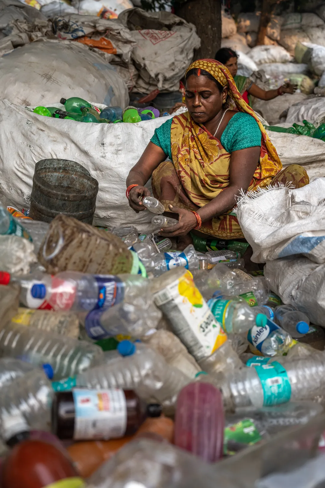 Fisherman Ganga Sanhi preparing his nets on the riverbank
