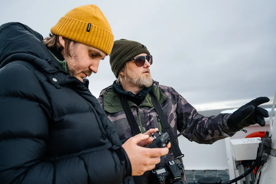 Two people reviewing a camera while capturing photogrammetry in the field